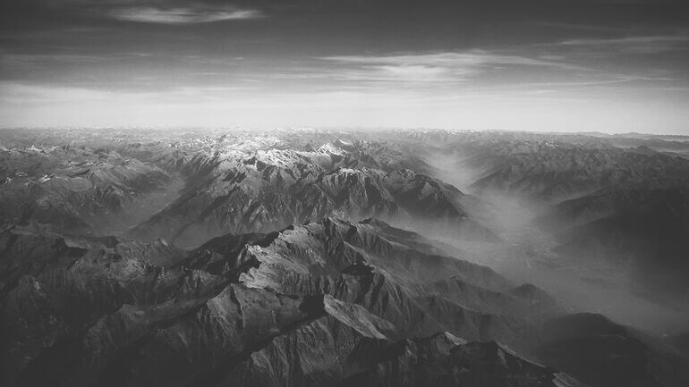 Arial view of mountains in black and white - Cookiebot