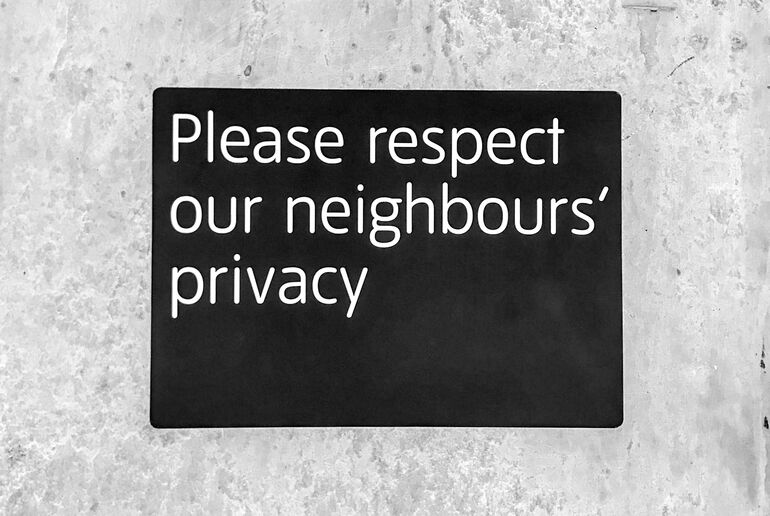 Sign reading 'Please respect our neighbours' privacy' - Cookiebot