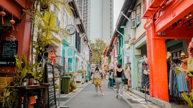 Person taking a photo of a street in Singapore - Cookiebot
