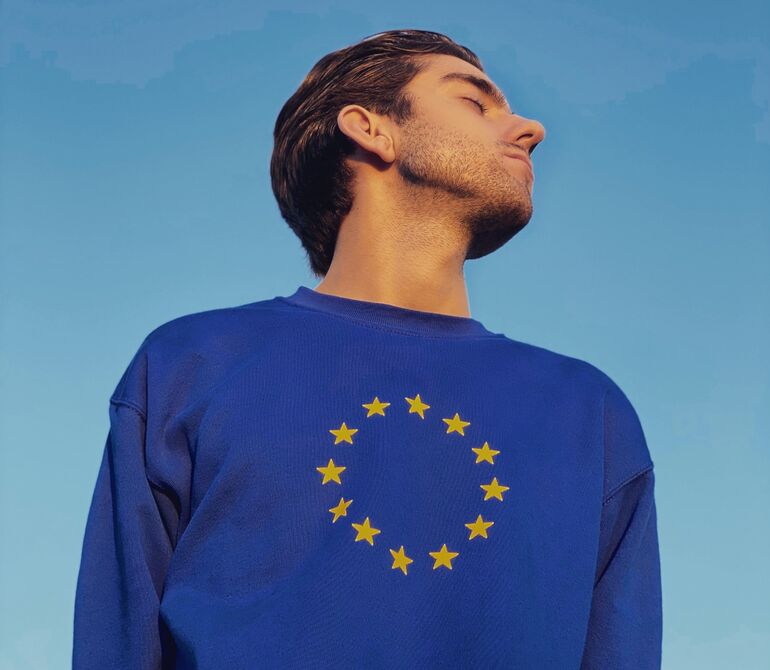 Man wearing a blue jumper featuring the European flag  - Cookiebot